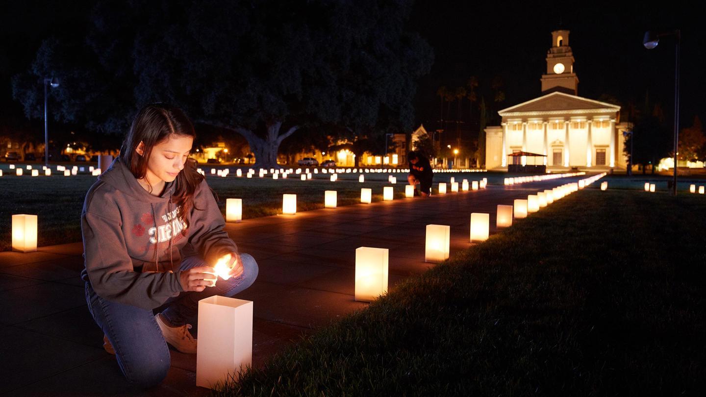 Media masthead - Feast of Lights luminary student lighting candle